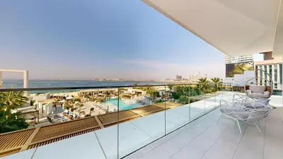 a balcony with a view of the ocean and a resort at Vacationer l Chic 2 Bedroom l Sea Views l Private Beach Access in Dubai