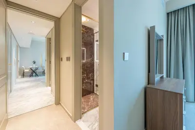 a hallway with a glass door leading to a dining room at Vacationer l Elegant 1 Bed l Next to Metro l Near Mall in Dubai