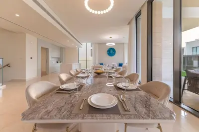 a dining room with a long table and chairs at Vacationer l Breathtaking 5 Bed Villa l Luxurious & Spacious in Dubai
