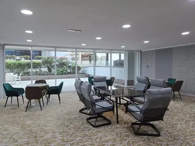 a conference room with a table and chairs and windows at Business Bay 1 BR on Canal 7 min to Dubai Mall in Dubai