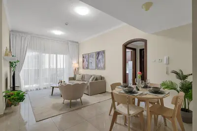 a living room with a table and a couch at Business Bay 1 BR on Canal 7 min to Dubai Mall in Dubai
