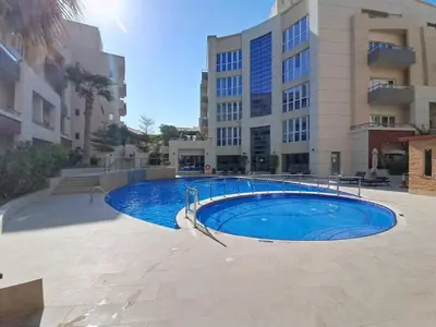 a large swimming pool in front of a building at Vacationer l Modern Aesthetic 1 Bed l JVC l near Circle Mall in Dubai