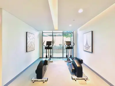 a gym with a row of chairs in a room at Waves - Beachfront Bliss - Marina Vista 1BR Escape in Dubai