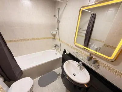 a bathroom with a sink and a tub and a toilet at Panoramic Fireworks Views with Palm Jumeirah Bluewaters and Ain dubai View in Dubai