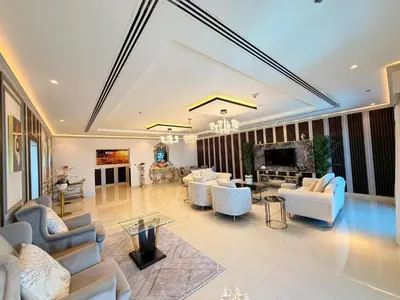 a large living room with couches and a tv at Panoramic Fireworks Views with Palm Jumeirah Bluewaters and Ain dubai View in Dubai