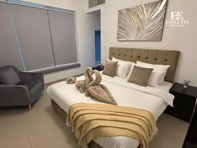 a bedroom with a large bed with towels on it at 2BR Downtown Dubai - Near Burj Khalifa - Private Podium Seating - Sleeps 4 in Dubai