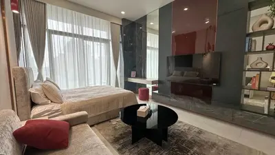 a bedroom with a bed and a couch and a table at Stylish new apartment with Burj and Downtown views in Dubai