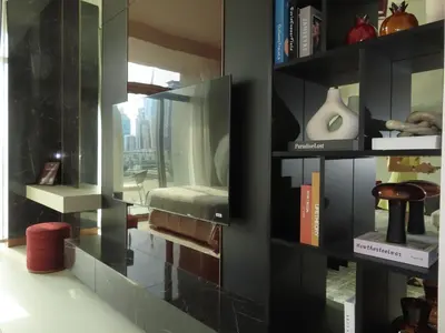 a room with a book shelf filled with books at Stylish new apartment with Burj and Downtown views in Dubai
