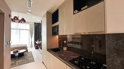 a kitchen with a black counter top in a room at Stylish new apartment with Burj and Downtown views in Dubai