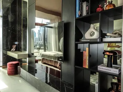 a room with black walls and shelves with books at Stylish new apartment with Burj and Downtown views in Dubai