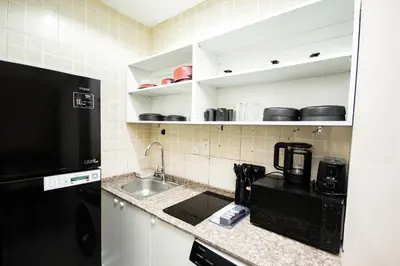 a kitchen with a sink and a coffee maker at Newly furnished Studio at city tower building in barsha 1 in Dubai