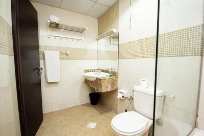 a bathroom with a toilet and a sink at Newly furnished Studio at city tower building in barsha 1 in Dubai