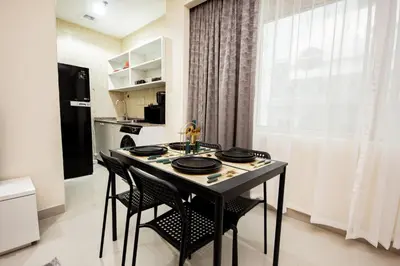 a kitchen with a table and chairs in a room at Newly furnished Studio at city tower building in barsha 1 in Dubai