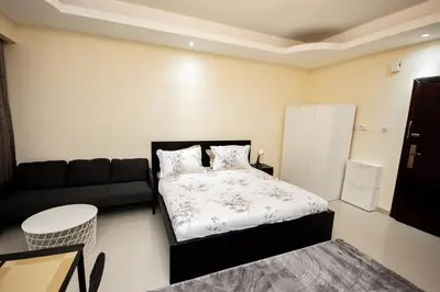 a small bedroom with a bed and a couch at Newly furnished Studio at city tower building in barsha 1 in Dubai