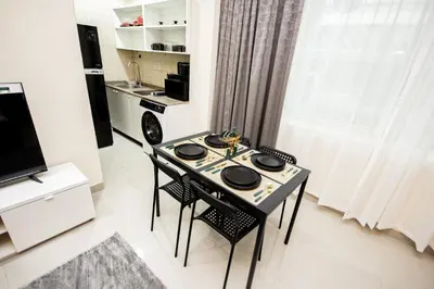 a kitchen with a table and chairs in a room at Newly furnished Studio at city tower building in barsha 1 in Dubai