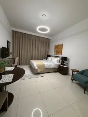 a bedroom with a bed and a living room at Cove Luxe Holiday Home JVC in Dubai