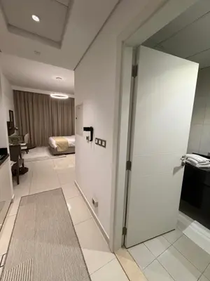 a room with a door leading to a bedroom at Cove Luxe Holiday Home JVC in Dubai