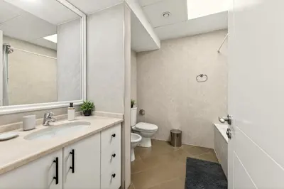 a bathroom with a sink and a toilet at Modern 1BR Apartment - Burj Khalifa View - Pool & Terrace - Near Metro in Dubai