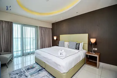 a bedroom with a large bed in a room with a large window at Luxury Escapes Premium 1BR - Paramount Tower Business Bay in Dubai