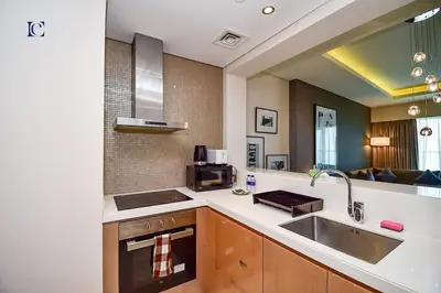 a kitchen with a sink and a microwave at Luxury Escapes Premium 1BR - Paramount Tower Business Bay in Dubai