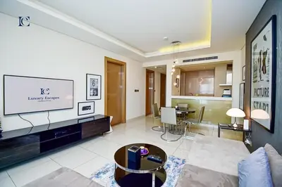 a living room with a couch and a tv at Luxury Escapes Premium 1BR - Paramount Tower Business Bay in Dubai