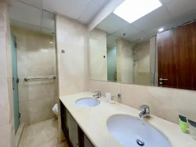 a bathroom with a sink and a large mirror at Charming 2BR in Dubai Marina with Lake View in Dubai