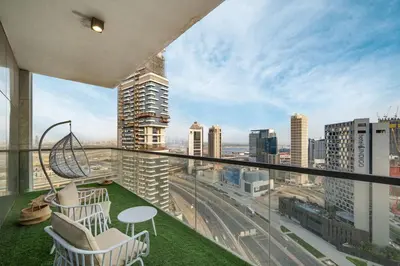 a balcony with chairs and a view of a city at Luxury 2BR in Mada Residences - Walk to Dubai Mall in Dubai