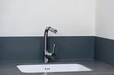 a kitchen sink with a faucet on a counter at Luxury 2BR in Mada Residences - Walk to Dubai Mall in Dubai