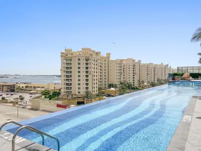 a large swimming pool on top of a building at Luxury 1BR in The Palm Tower Near Nakheel Mall in Dubai