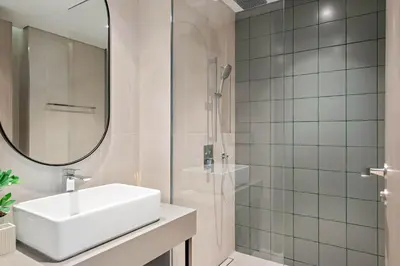 a white bathroom with a sink and a shower at Silkhaus Luxury New Tower in City Walk in Dubai