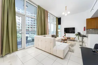 a living room with a couch and a large window at Urban apartment near to Dubai mall & Burj Khalifa in Dubai