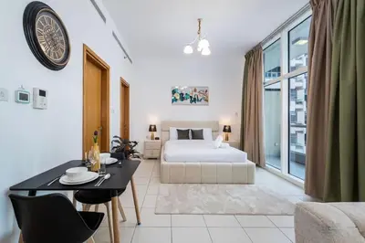 a bedroom with a king sized bed and a table and chairs at Urban apartment near to Dubai mall & Burj Khalifa in Dubai