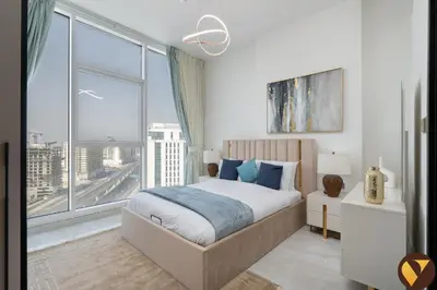 a bedroom with a bed and a large window at Vogue Al Furjan Gemz by Danube near Ibn Battuta Mall, Three Bedroom plus Kids room Apartment with Balcony and Private Pool, Access to all amenities in Dubai