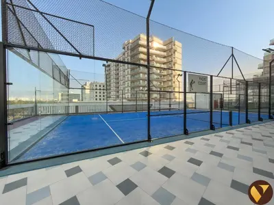 a tennis court on top of a building at Vogue Al Furjan Gemz by Danube near Ibn Battuta Mall, Three Bedroom plus Kids room Apartment with Balcony and Private Pool, Access to all amenities in Dubai