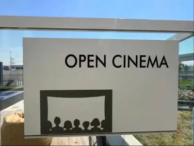 a sign for an open cinema on a building at Vogue Al Furjan Gemz by Danube near Ibn Battuta Mall, Three Bedroom plus Kids room Apartment with Balcony and Private Pool, Access to all amenities in Dubai