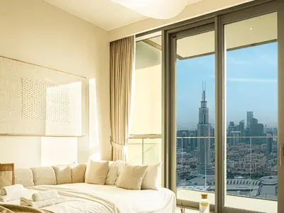 a bedroom with a bed and a large window at Downtown Views Suites by Prestige Nest in Dubai