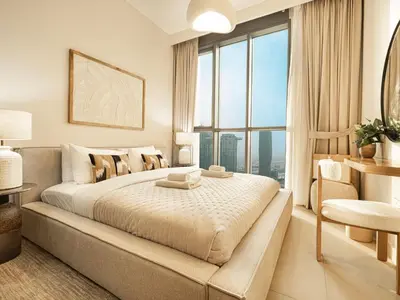 a bedroom with a large bed with a large window at Downtown Views Suites by Prestige Nest in Dubai