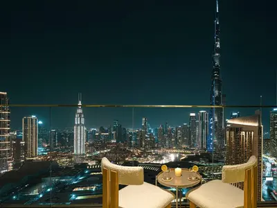a room with a view of a city at night at Downtown Views Suites by Prestige Nest in Dubai
