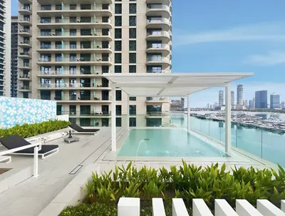 a swimming pool on the roof of a building at 2BR Beachfront Retreat with Palm and Dubai Eye Views in Dubai