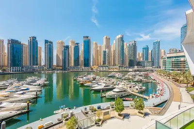 a city with boats docked in a marina at 2BR Beachfront Retreat with Palm and Dubai Eye Views in Dubai