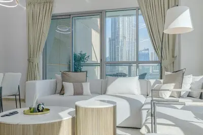 a living room with a white couch and a large window at Burj Khalifa View - 2 Bedroom apartment at The Residence 5, Downtown - Allsopp & Allsopp in Dubai