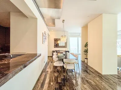 a kitchen and dining room with a table and chairs at Marina Sky Luxe Penthouse in Dubai