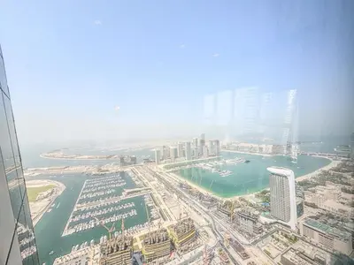 an aerial view of a city with buildings and a harbor at Marina Sky Luxe Penthouse in Dubai