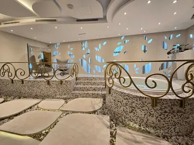 a room with two benches and a wall with blue paintings at Marina Sky Luxe Penthouse in Dubai