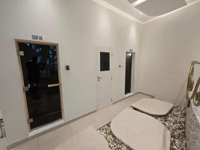 a white room with two toilets and a window at Marina Sky Luxe Penthouse in Dubai
