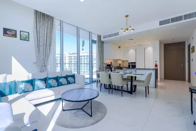 a living room with a couch and a table at TRPS - District One Residences, MBR - Brand New 3BR plus Maids, Lagoon View, Fully Furnished in Dubai
