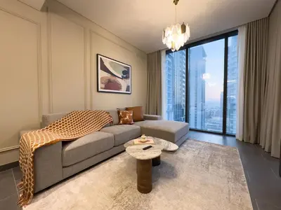 a living room with a couch and a table at Werova-Cozy 2-Bedroom Apartment w Stunning Views in Dubai