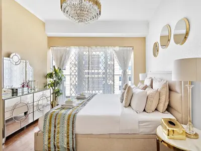 a bedroom with a large white bed and a window at Luxury Fendi with Stunning Marina Views in Dubai