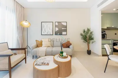 a living room with a couch and a table at Steps from the Park, Mall and The Green Planet, Minutes to Metro with Easy Access to Downtown Attractions, Myrtle, Al Wasl by Deluxe Holiday Homes in Dubai
