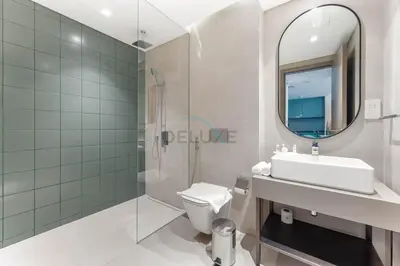 a bathroom with a sink toilet and a mirror at Steps from the Park, Mall and The Green Planet, Minutes to Metro with Easy Access to Downtown Attractions, Myrtle, Al Wasl by Deluxe Holiday Homes in Dubai